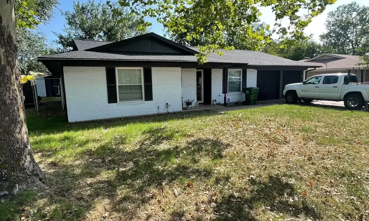 Professional roofing crew working on a residential roof in Pevely